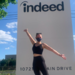 Ekaterina posed before Indeed office sign