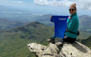 Helen climbing Snowdon in Wales with Indeed swag